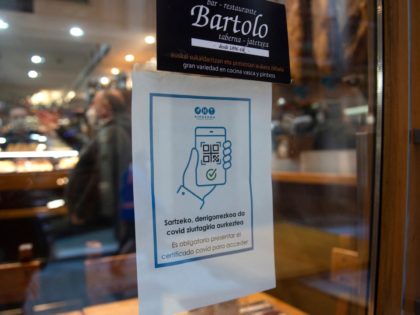 This photograph shows a placard reading "It is mandatory to present a covid certificate to enter" on a bar's door of the Spanish Basque city of San Sebastian on December 15, 2021, as it becomes mandatory in the Basque Country in restaurants, bars, sports centres, hospitals, gyms, nursing homes and …