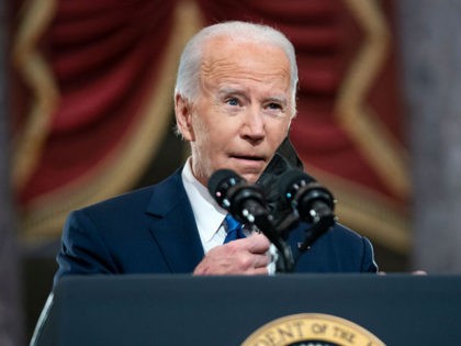 WASHINGTON, DC - JANUARY 06: US President Joe Biden removes his mask before giving remarks