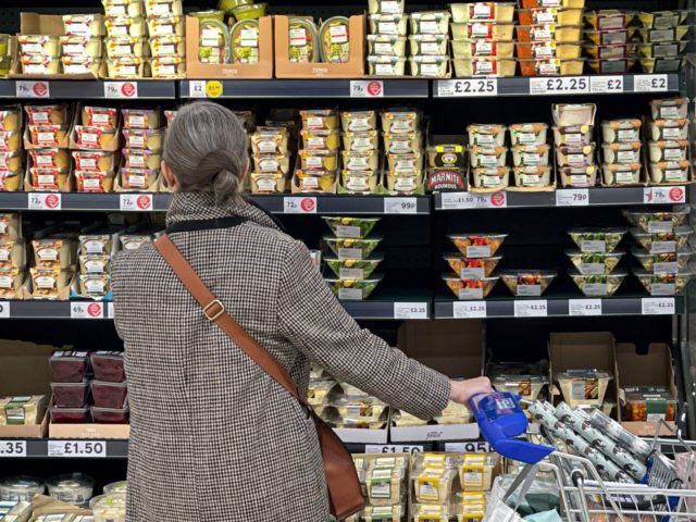 A customer shops for food items inside a Tesco supermarket store in east London on January 10, 2022. - UK annual inflation rocketed last November to 5.1 percent, more than double the Bank of England's 2.0-percent target -- price rises for fuel, clothing, food, second-hand cars and increased tobacco duty …