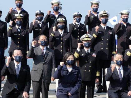 Taiwan President Tsai Ing-wen (front C) gestures with navy soldiers during the domestically produced mine laying ships inauguration ceremony at a navy base in Kaohsiung, southern Taiwan, on January 14, 2022.