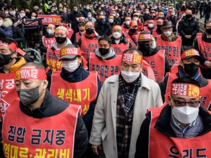 TOPSHOT - Small business owners gather during a protest against the government's Covid-19 social distancing measures in Seoul on January 25, 2022.