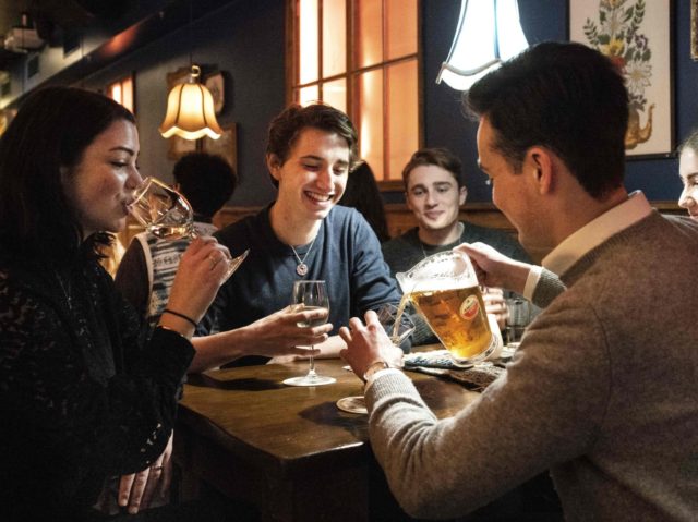 People have drinks at a bar along the Rembrandtplein as cafes and restaurants reopened following the relaxation of the Covid-19 measures, in Amstrdam on January 26, 2022. - The Netherlands lifted some of Europe's toughest Covid restrictions with bars, restaurants and museums allowed to reopen their doors, Prime Minister Mark …