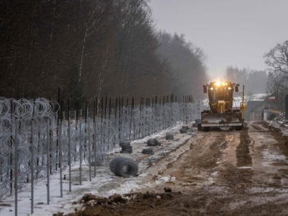 Workers construct a border wall along the Polish-Belarus border in Tolcze, Sokolka County,