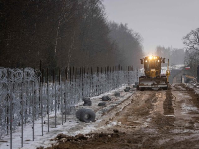 Workers construct a border wall along the Polish-Belarus border in Tolcze, Sokolka County, Podlaskie Voivodeship, in north-eastern Poland on January 27, 2022. - Polish contractors began work on a 353-million euro wall along the Belarus border aimed at deterring migrant crossings following a crisis in the area last year. The …