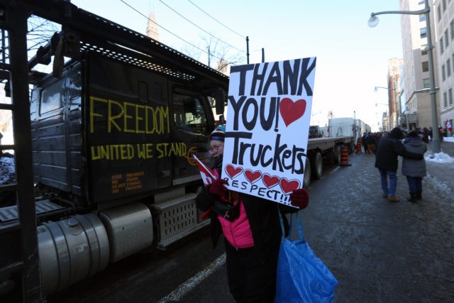 Supporters of the Freedom Convoy protest Covid-19 vaccine mandates and restrictions in front of Parliament on January 29, 2022 in Ottawa, Canada. - Hundreds of truckers drove their giant rigs into the Canadian capital Ottawa on Saturday as part of a self-titled "Freedom Convoy" to protest vaccine mandates required to …