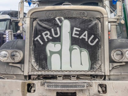 OTTAWA, ON - JANUARY 30: (EDITORS NOTE: Image contains profanity.) A flag depicting profanity against Prime Minister Justin Trudeau hangs from the front of a truck on January 29, 2022 in Ottawa, Canada. Thousands turned up over the weekend to rally in support of truckers using their vehicles to block …