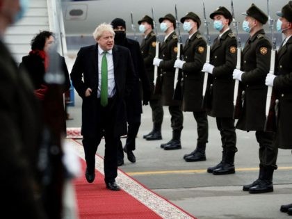 Britain's Prime Minister Boris Johnson is greeted by honour guard as he arrives at the Kyiv International Airport, on February 1, 2022. - Ukrainian President Volodymyr Zelensky on February 1, 2022 said Western military and diplomatic support had reached it highest level since the year Crimea was annexed, as fears …