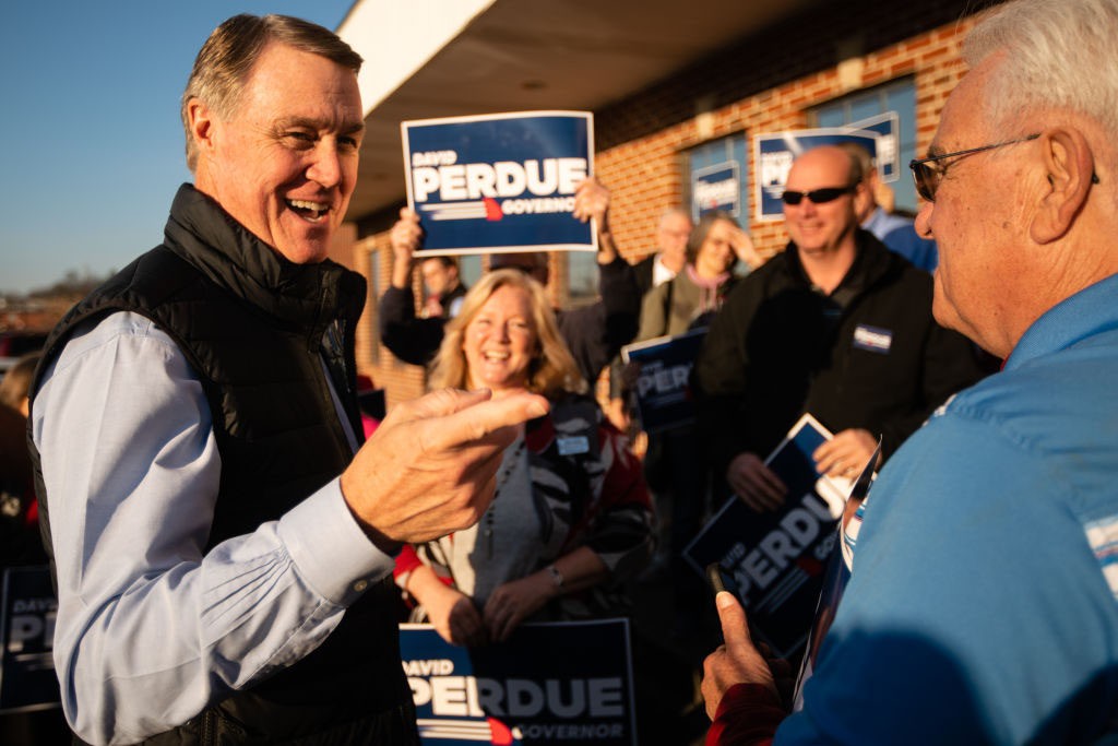 DALTON, GA - FEBRUARY 01: Former U.S. senator and Republican gubernatorial candidate David Perdue greets supporters at a campaign event on February 1, 2022 in Dalton, Georgia. Purdue kicked off his campaign, in which he will first face incumbent Republican Gov. Brian Kemp in the May primary, the winner of which will face likely Democratic candidate Stacey Abrams, speaking on teacher pay and law enforcement. The Perdue campaign aired a video endorsement by former President Donald Trump at the event. (Photo by Elijah Nouvelage/Getty Images)