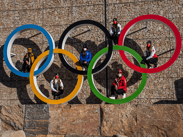 National team members pose for photographs on Olympic Rings at Yanqing Olympic Village on