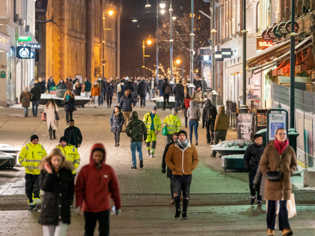 People walk along a pedestrian zone in Oslo on February 2, 2022 as the gastronomy reopens