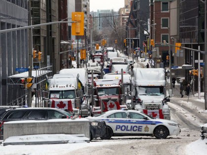 Trucks parked in downtown Ottawa continue to protest Covid-19 vaccine mandates and restrictions, on February 4, 2022 in Ottawa, Canada. - Hundreds of truckers drove their giant rigs into the Canadian capital on January 29, 2022, as part of a self-titled "Freedom Convoy" to protest vaccine mandates required to cross …