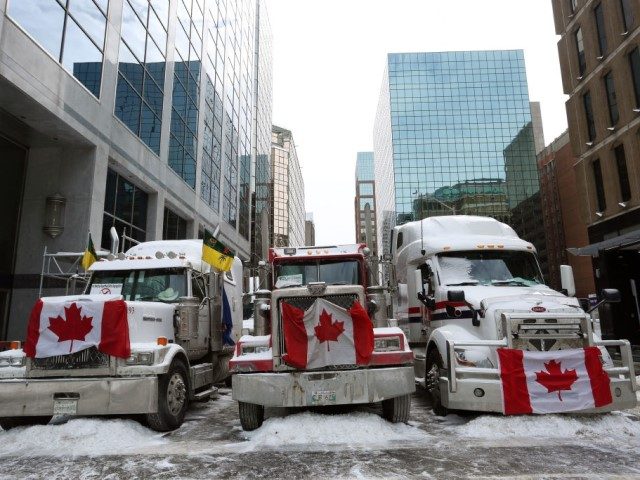 Trucks parked in downtown Ottawa continue to protest Covid-19 vaccine mandates and restrictions, on February 4, 2022 in Ottawa, Canada. - Hundreds of truckers drove their giant rigs into the Canadian capital Ottawa on January 29, 2022, as part of a self-titled "Freedom Convoy" to protest vaccine mandates required to …