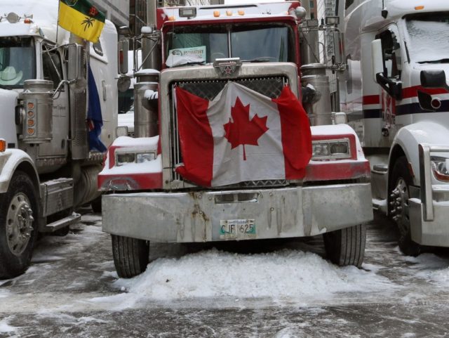 Trucks parked in downtown Ottawa continue to protest Covid-19 vaccine mandates and restrictions, on February 4, 2022 in Ottawa, Canada. - Hundreds of truckers drove their giant rigs into the Canadian capital Ottawa on January 29, 2022, as part of a self-titled "Freedom Convoy" to protest vaccine mandates required to …