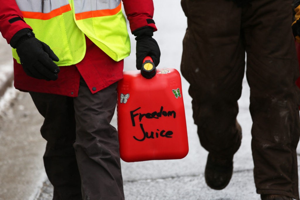 A person carries a fuel can on Wellington street as demonstrators continue to protest the Covid-19 vaccine mandates implemented by Prime Minister Justin Trudeau on February 9, 2022, in Ottawa, Canada. (Photo by Dave Chan / AFP) (Photo by DAVE CHAN/AFP via Getty Images)