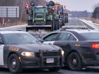 TOPSHOT - Farmers block Highway 402 to protest against vaccine mandates near Sarnia, Ontario on February 10, 2022. - The highway serves as an alternate route to the United States and has been taking the traffic diverted from the Windsor- Detroit border crossing which has been blocked by protestors since …
