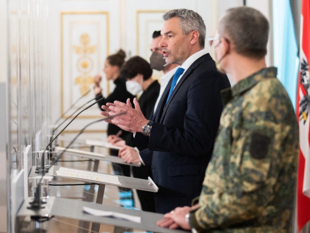 Austrian Chancellor Karl Nehammer (2R) attends a press conference on corona virus restrictions in Vienna on February 16, 2022. - Chancellor Karl Nehammer said the government would drop most measures from March 5, including lifting entry restrictions to restaurants, hotels and at cultural and sports venues. - Austria OUT (Photo …