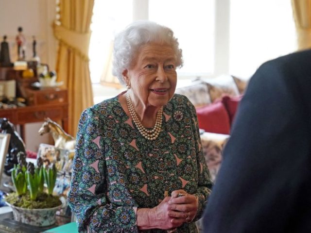 Britain's Queen Elizabeth II (L) speaks with incoming Defence Service Secretaries Maj