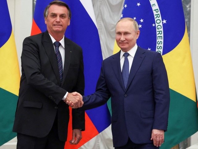Russian President Vladimir Putin (R) shakes hands with Brazil's President Jair Bolsonaro d