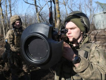 Servicemen of Ukrainian Military Forces on the front-line with Russia-backed separatists near Novognativka village, Donetsk region, examine a Swedish-British portable anti-tank guided missile NLAW that was transferred to the units as part of Britain's military-technical assistance, on February 21, 2022.