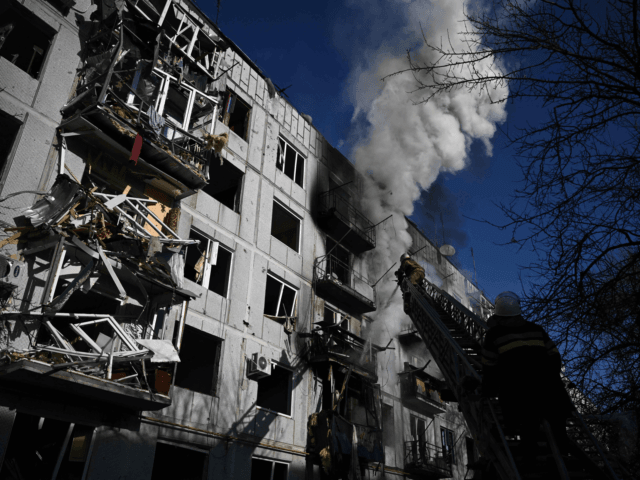 Firefighters work on a fire on a building after bombings on the eastern Ukraine town of Ch