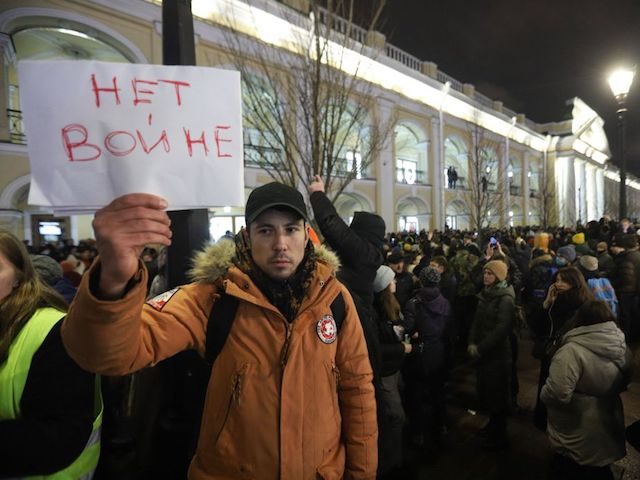 A demonstrator holding a placard reading "No to war" protests against Russia's invasion of