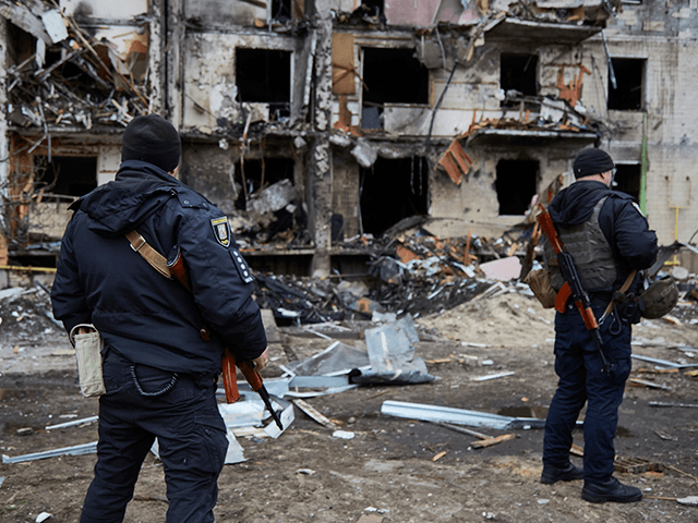 Ukrainian police officers outside a residential building damaged by a missile on February 25, 2022 in Kyiv, Ukraine. Yesterday, Russia began a large-scale attack on Ukraine, with Russian troops invading the country from the north, east and south, accompanied by air strikes and shelling. The Ukrainian president said that at least 137 Ukrainian soldiers were killed by the end of the first day. (Photo by Pierre Crom/Getty Images)