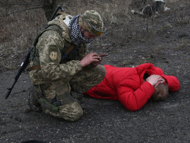 A Ukrainian serviceman checks on a man who was acting suspicious not far from the positions on Ukraine's service members in Lugansk region on February 26, 2022. - Russia on February 26 ordered its troops to advance in Ukraine "from all directions" as the Ukrainian capital Kyiv imposed a blanket …