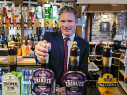 FALMOUTH, ENGLAND - JULY 29: Labour Leader Sir Keir Starmer pulls a pint of "Tribute" behi