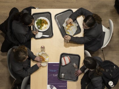 CHERTSEY, UNITED KINGDOM - MARCH 09: (EDITORIAL USE ONLY) Pupils eat lunch in the canteen on their first day back from lockdown at Chertsey High School on March 09, 2021 in Chertsey, United Kingdom. Chertsey High school, which is part of the Bourne Education Trust, is continuing to conduct lateral …