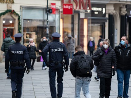 VIENNA, AUSTRIA - NOVEMBER 22: Police patrols 'Am Graben' shopping street on the first day of a nationwide, temporary lockdown during the fourth wave of the novel coronavirus pandemic on November 22, 2021 in Vienna, Austria. The measure, in which people are only allowed to leave home for essentials and …