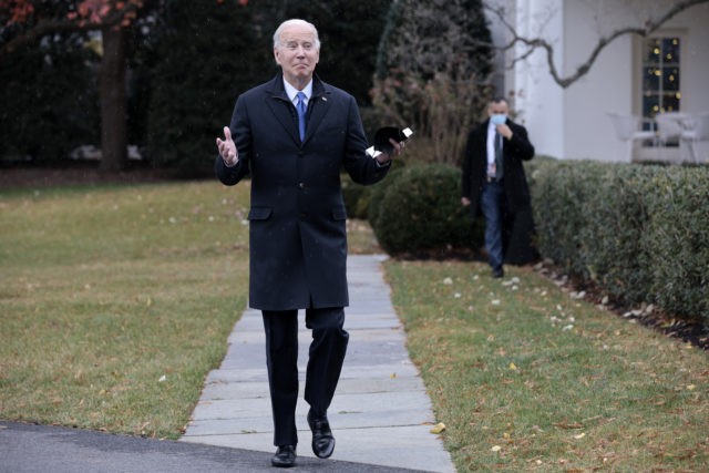 WASHINGTON, DC - DECEMBER 08: U.S. President Joe Biden gestures as a light snow falls whil