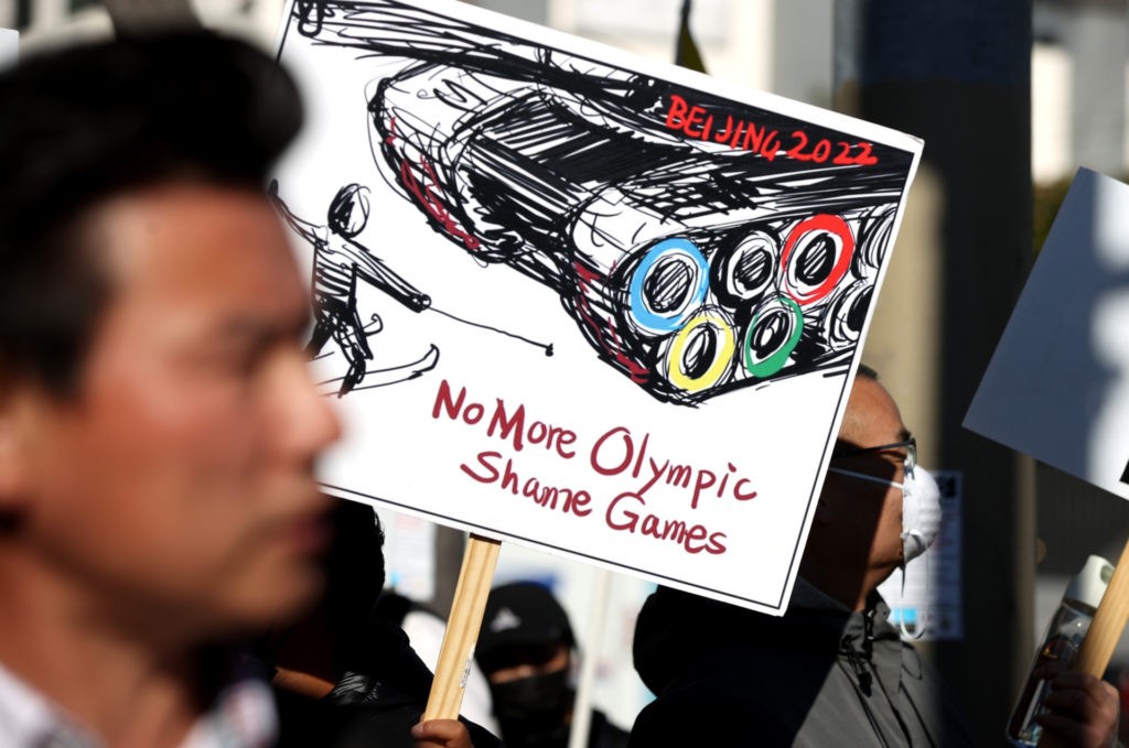 SAN FRANCISCO, CALIFORNIA - DECEMBER 10: Protesters hold signs during a demonstration outside of the NBC Sports office on December 10, 2021 in San Francisco, California. Dozens of Tibetan and human rights activists staged a protest outside of the NBC Sports office to demand that the network not broadcast the 2022 Winter Olympic Games from Beijing, China due to the country's human rights abuses. (Photo by Justin Sullivan/Getty Images)