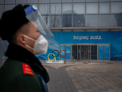 A security guard stands behind a barricade in an area not accessible to the general public, that will host Beijing 2022 Winter Olympics at Olympic Park on January 23, 2022 in Beijing, China. (Photo by Andrea Verdelli/Getty Images)