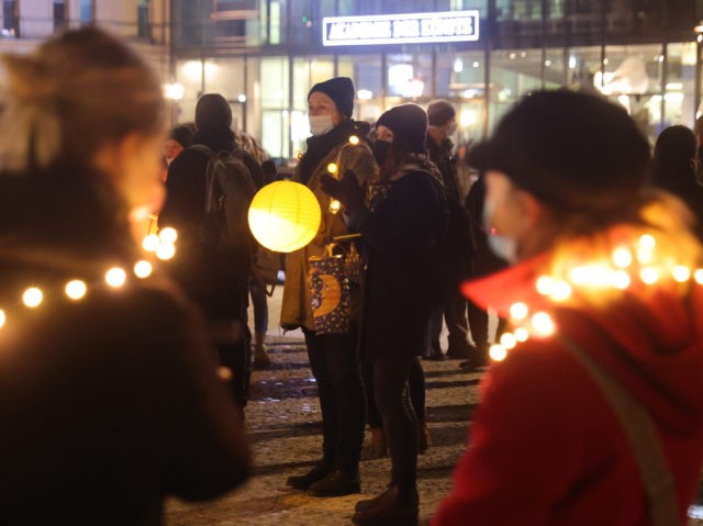 BERLIN, GERMANY - JANUARY 31: People with lanterns and lights gather to protest against va