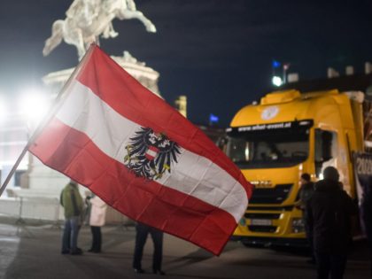 VIENNA, AUSTRIA - FEBRUARY 11: Anti-coronavirus lockdown measures and anti-vaccination protesters stand among long-haul trucks in a gathering inspired by the current "Freedom Convoy" blockades in Canada on February 11, 2022 in Vienna, Austria. The Canadian "Freedom Convoy" protests have begun leading to similar protests elsewhere, including today in Austria …