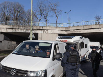 PARIS, FRANCE - FEBRUARY 12: Police stop members of a "Freedom Convoy" along a street on F
