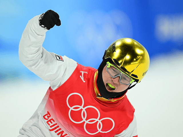 Qi Guangpu of Team China reacts after completing a run during the Men's Freestyle Skiing A