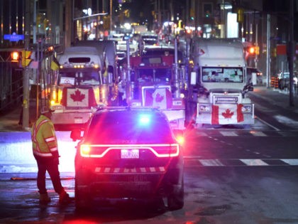 OTTAWA, ONTARIO - FEBRUARY 15: A police vehicle blocks a downtown street to prevent trucks from joining a blockade of truckers protesting vaccine mandates near the Parliament Buildings on February 15, 2022 in Ottawa, Ontario, Canada Prime Minister Justin Trudeau has invoked the Emergencies Act for the first time in …