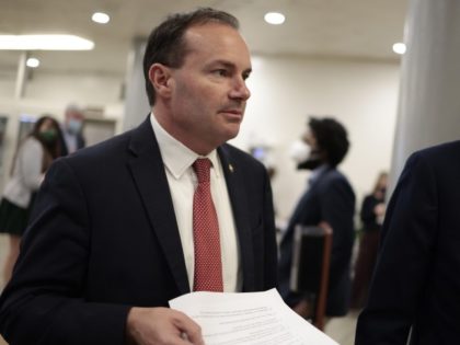 WASHINGTON, DC - FEBRUARY 16: Sen. Mike Lee (R-UT) speaks to a reporter as he walks through the Senate subway during a series of votes on Capitol Hill on February 16, 2022 in Washington, DC. Senators continue to work towards passing legislation to keep the government open as a funding …