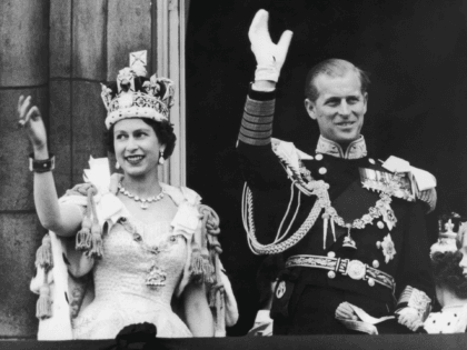 Queen Elizabeth II and the Duke of Edinburgh wave at the crowds from the balcony at Buckin
