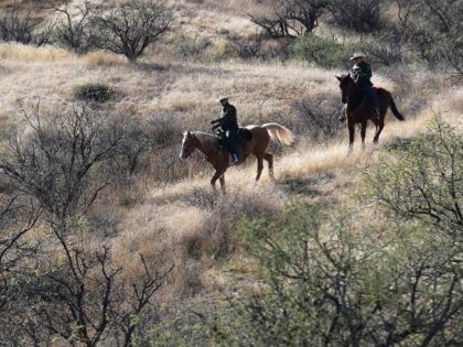NOGALES, AZ - DECEMBER 09: Mounted U.S. Border Patrol agents ride near the U.S.-Mexico border on December 9, 2014 near Nogales, Arizona. With increased manpower and funding in recent years, the Border Patol has seen the number illegal crossings and apprehensions of undocumented immigrants decrease in the Tucson sector. Agents …