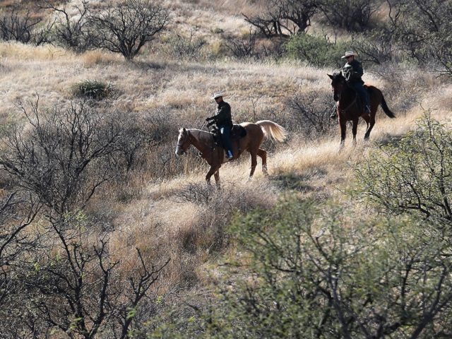 NOGALES, AZ - DECEMBER 09: Mounted U.S. Border Patrol agents ride near the U.S.-Mexico bor