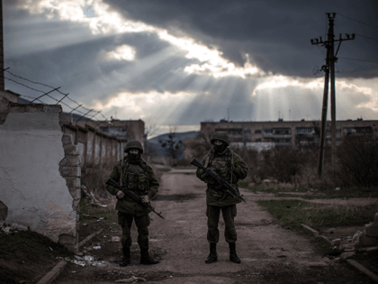 Armed men believed to be Russian military stand outside a Ukrainian military base on March 12, 2014 in Simferopol, Ukraine. As the standoff between the Russian military and Ukrainian forces continues in Ukraine's Crimean peninsula, world leaders are pushing for a diplomatic solution to the escalating situation. Crimean citizens will …