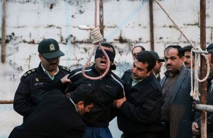 Balal, who killed Iranian youth Abdolah Hosseinzadeh in a street fight with a knife in 2007, is brought to the gallows during his execution ceremony in the northern city of Noor on April 15, 2014. The mother of Abdolah Hosseinzadeh spared the life of the her son's convicted murderer, with …