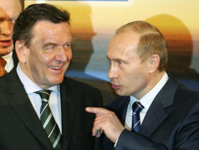 HANOVER, GERMANY - APRIL 11: Russian President Vladimir Putin (R) and the German chancellor Gerhard Schroeder (L) poses at the opening of the Hanover Fair 2005, a trade fair for industrial technology April 11, 2005 at the Trade Fair Center in Hanover, Germany. (Photo by Andreas Rentz/Getty Images)