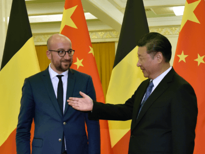 China's President Xi Jinping (R) gestures as he welcomes Belgium's Prime Minister Charles Michel and his delegation ahead of their meeting at the Great Hall of the People in Beijing on October 31, 2016. / AFP / POOL / KENZABURO FUKUHARA (Photo credit should read KENZABURO FUKUHARA/AFP via Getty Images)