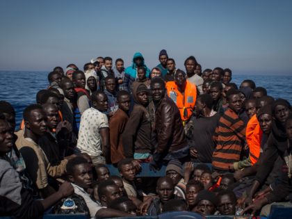 LAMPEDUSA, ITALY - MAY 18: Refugees and migrants wait to be rescued from a small wooden boat by crew members from the Migrant Offshore Aid Station (MOAS) Phoenix vessel on May 18, 2017 off Lampedusa, Italy. Numbers of refugees and migrants attempting the dangerous central Mediterranean crossing from Libya to …