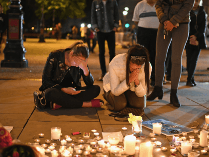 MANCHESTER, ENGLAND - MAY 23: Members of the public attend a candlelit vigil, to honour th