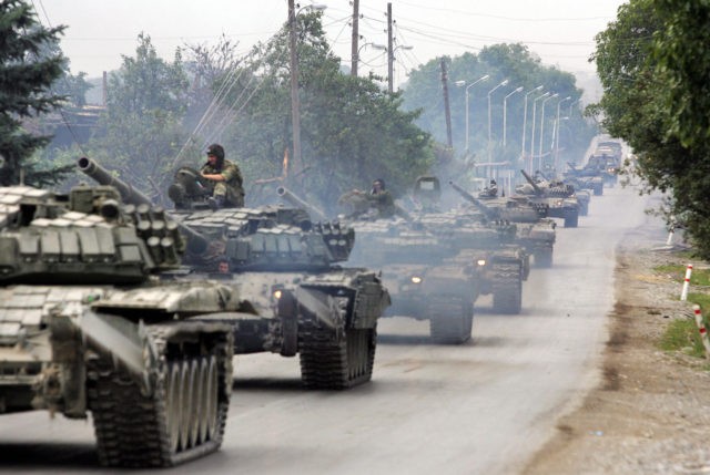 A column of Russian tanks moves on the road on August 21, 2008, not far from Tskhinvali to the border of Russian Federation. Russia's withdrawal of all its forces from Georgia will be completed on August 22, Defence Minister Anatoly Serdyukov announced on August 21, quoted by the Interfax news …