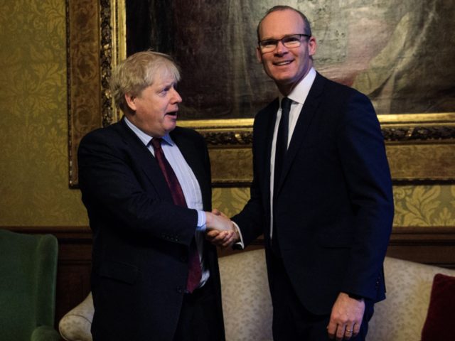 British Foreign Secretary Boris Johnson (L) greets the Irish Foreign Minister Simon Covene
